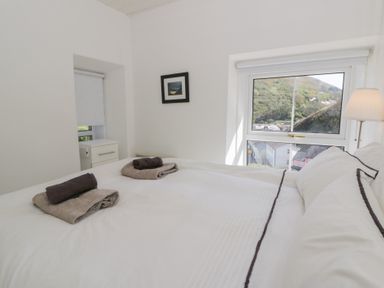 A bedroom with a bed and window at Brynmorfa in Llandysul