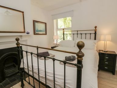A bedroom with a bed and bedside table at Brynmorfa in Llandysul
