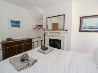 A bedroom with a bed and towels arranged at Brynmorfa in Llandysul
