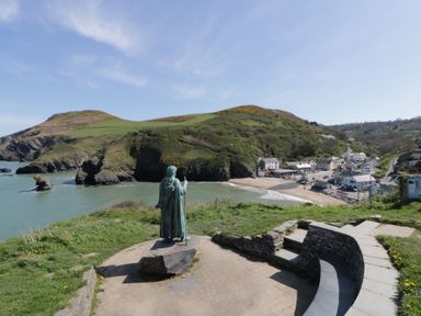 A view of the coastline with a statue overlooking the sea at Brynmorfa in Llandysul