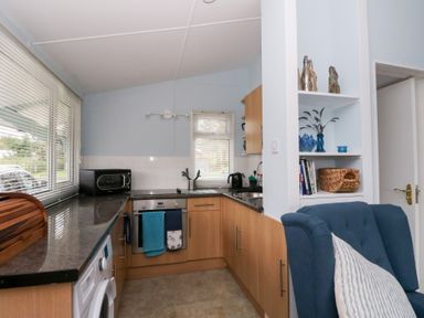 A kitchen with appliances and furniture at Scarba in Oban