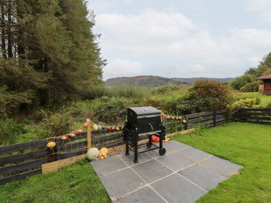 An outdoor area with a grill and decorative items at Scarba in Oban