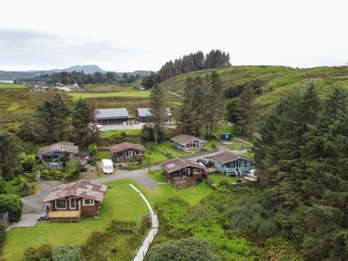 An outdoor area with cabins and trees at Scarba, Balvicar, Isle Of Seil