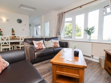 A living room with a sofa and table at Castle View Lodge Ilfracombe