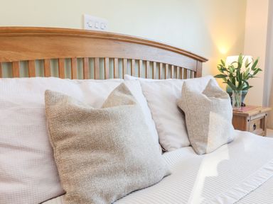 A bedroom with a bed and pillows at Castle View Lodge in Ilfracombe