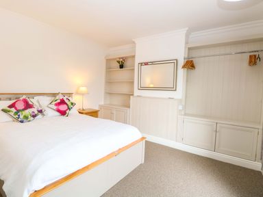 A bedroom with a bed and shelf at Highland House in Sheringham