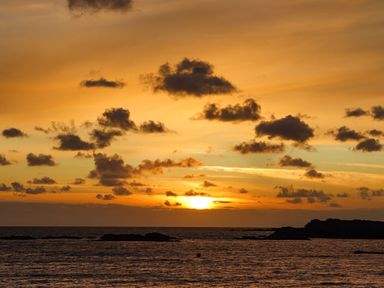 An ocean view with rocks and clouds during sunset at Seaddler in Trearddur Bay