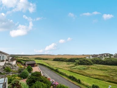 A view of houses and open fields at Seaddler in Trearddur Bay