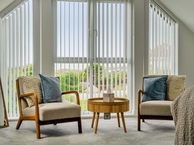 A living room with two chairs and a coffee table at Seaddler in Trearddur Bay