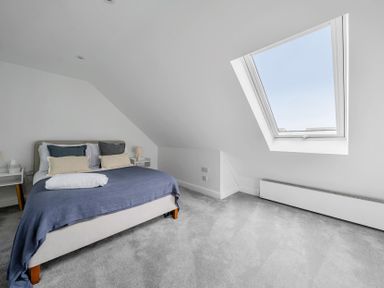 A bedroom with a bed and window at Seaddler in Trearddur Bay