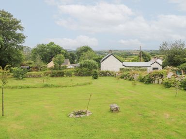 A garden with grass and trees at Teg in Prospidnick near Porthleven