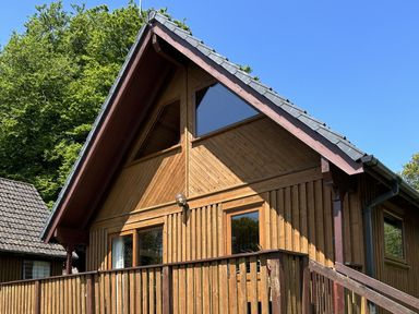 A wooden cabin with a deck and large windows at Number 39 Bodmin