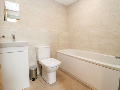 A bathroom with a sink, toilet, and bathtub in Bears Court Barn 3 Little Rissington near Bourton-On-The-Water