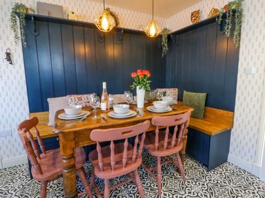 A dining room with a table and chairs at La Bastille in Maenclochog