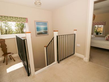 A landing with a staircase and window at La Bastille in Maenclochog