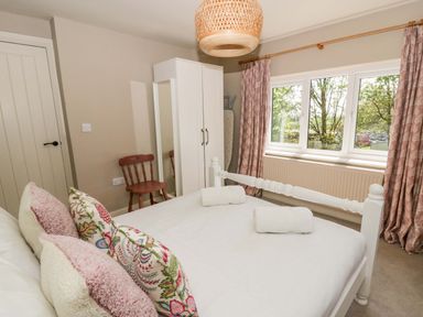 A bedroom with a bed and wardrobe at La Bastille in Maenclochog