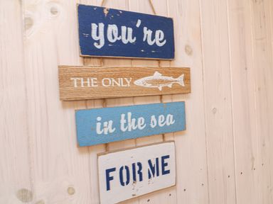 A wooden sign on a wall with the text youre the only fish in the sea for me at Barley Bay near Hartland