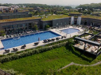 Outdoor swimming pools with lounge chairs surrounding them at Una Lodge 77 in Carbis Bay