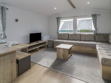 A living room with a sofa and coffee table at Lido Silver Plus 111 Prestatyn