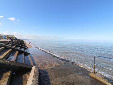 A beach with steps leading to the sea at Lido Silver Plus 111 in Prestatyn