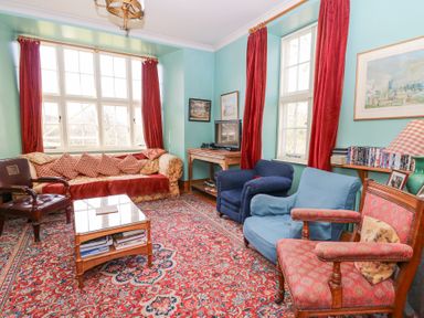 A sitting room with armchairs sofa coffee table and television at Plas Pontfaen near Fishguard and Newport Pembrokeshire