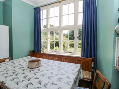 A dining room with a table and chairs at Plas Pontfaen near Fishguard and Newport, Pembrokeshire