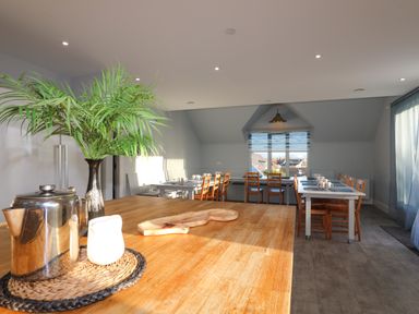 A dining room with wooden tables and chairs a metal kettle a vase with green leaves and windows with blue blinds at Plas Gwylan in Rhosneigr