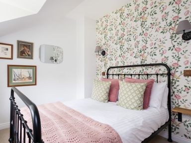 A bedroom with a bed and wall art at Henhouse Farm in Bodenham