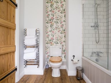 A bathroom with a toilet and bathtub at Henhouse Farm in Bodenham