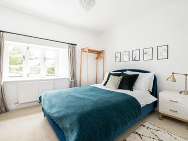 A bedroom with a bed and a hanging rack at Henhouse Farm Bodenham