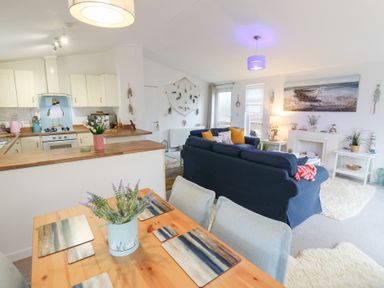 A living room with a kitchen area and dining table at The Sanctuary Badgers Retreat Holiday Park near Catterick Garrison, North Yorkshire