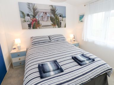 A bedroom with a bed and nightstand at The Sanctuary Badgers Retreat Holiday Park near Catterick Garrison, North Yorkshire