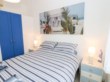 A bedroom with a bed and a wardrobe at The Sanctuary Badgers Retreat Holiday Park near Catterick Garrison, North Yorkshire
