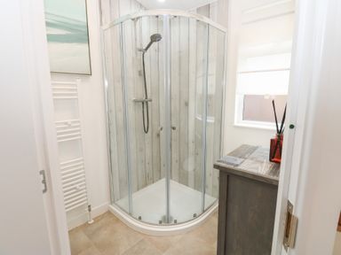 A bathroom with a shower enclosure and a sink at The Sanctuary Badgers Retreat Holiday Park near Catterick Garrison, North Yorkshire
