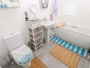 A bathroom with a sink, toilet, and bath tub at The Sanctuary near Badgers Retreat Holiday Park near Catterick Garrison, North Yorkshire