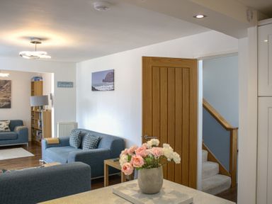 A living room with a sofa and bookshelf at Maceley in Kingsbridge