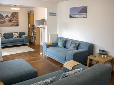 A living room with sofas and a bookshelf at Maceley in Kingsbridge