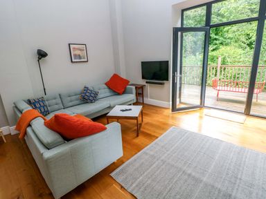 A living room with a sofa and coffee table at The Old Creamery in Ffairfach
