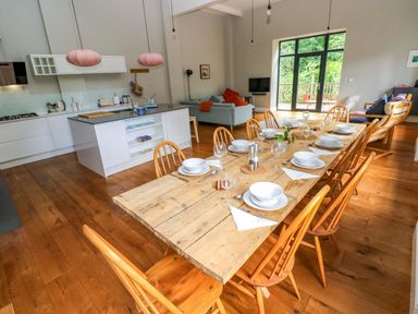 A kitchen with a dining table and chairs at The Old Creamery in Ffairfach