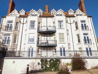 A multi-story residential building with balconies and windows at Apartment 7 Mansion House in Tenby