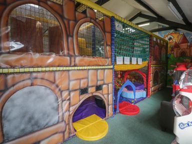 A play area with a large play structure and a ball pit at Gold Caravan (316) Talybont