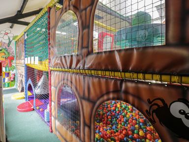 A play area with colorful balls and play structures at the indoor playground