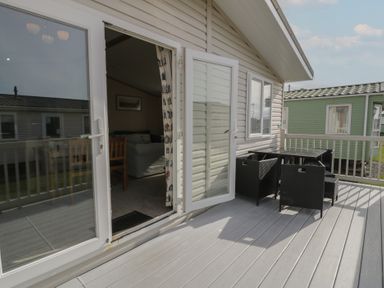 An outdoor area with a table and chairs at Gold Lodge (201) Talybont