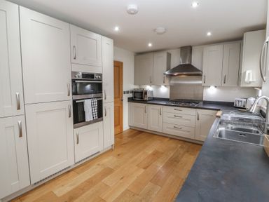 A kitchen with built in oven microwave gas stove and stainless steel sink at 4 Centurion Rise Penrith