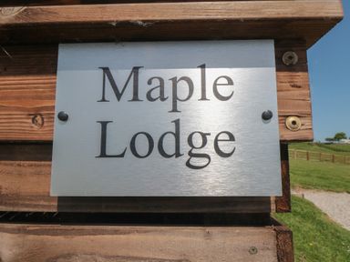A sign displaying Maple Lodge located in Whitby