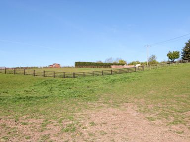 An outdoor scene with a horse and a fence at Fir Lodge in Whitby