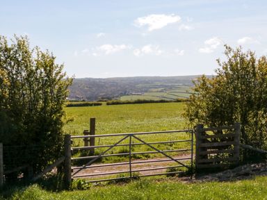 A gate leading to fields with trees at Fir Lodge in Whitby