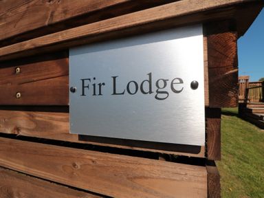 A sign displaying the name Fir Lodge