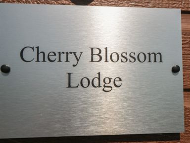 A sign displaying the name Cherry Blossom Lodge