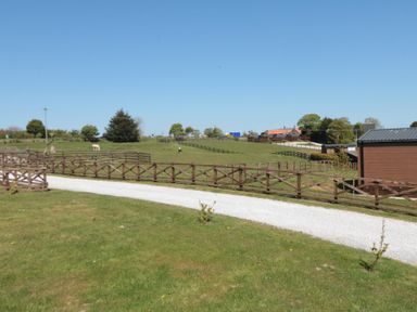 An outdoor area with a fence and pathway at Cherry Blossom Lodge in Whitby